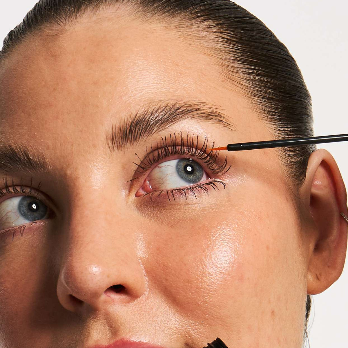 Applying the lash serum as part of an evening routine